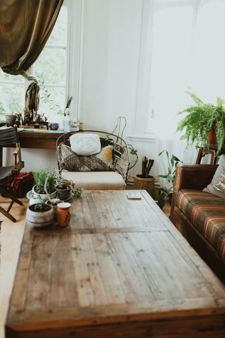 A stylish, modern living room featuring wood furniture and lush plants, epitomizing Scandinavian design.